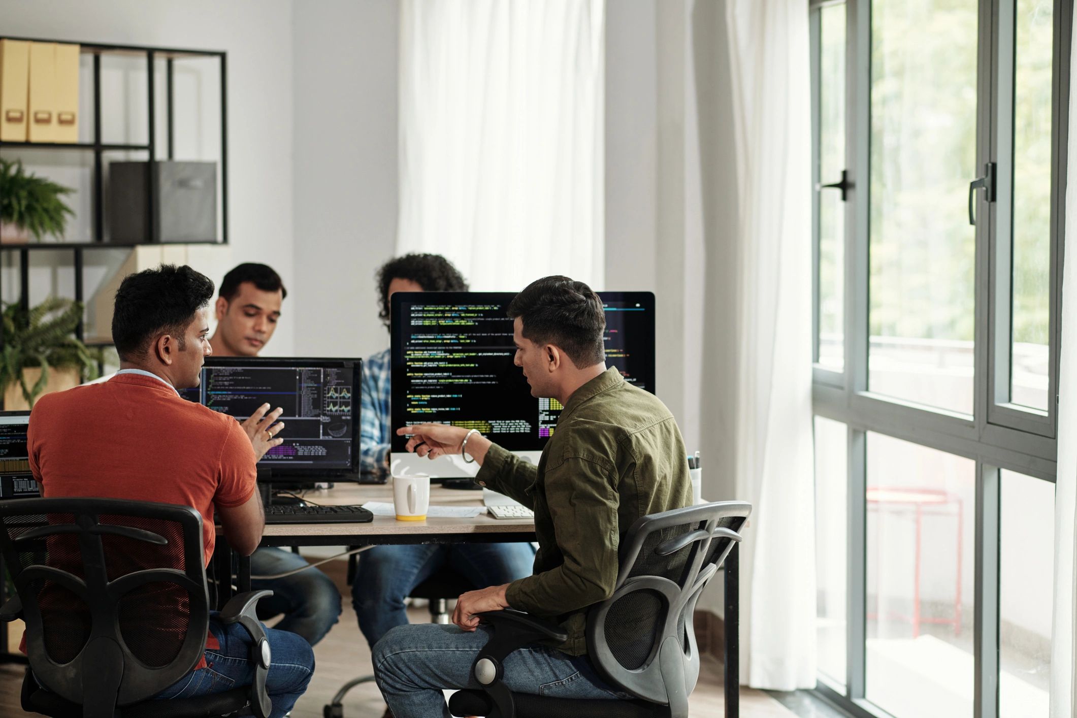 Developers discussing programming code during a planning session