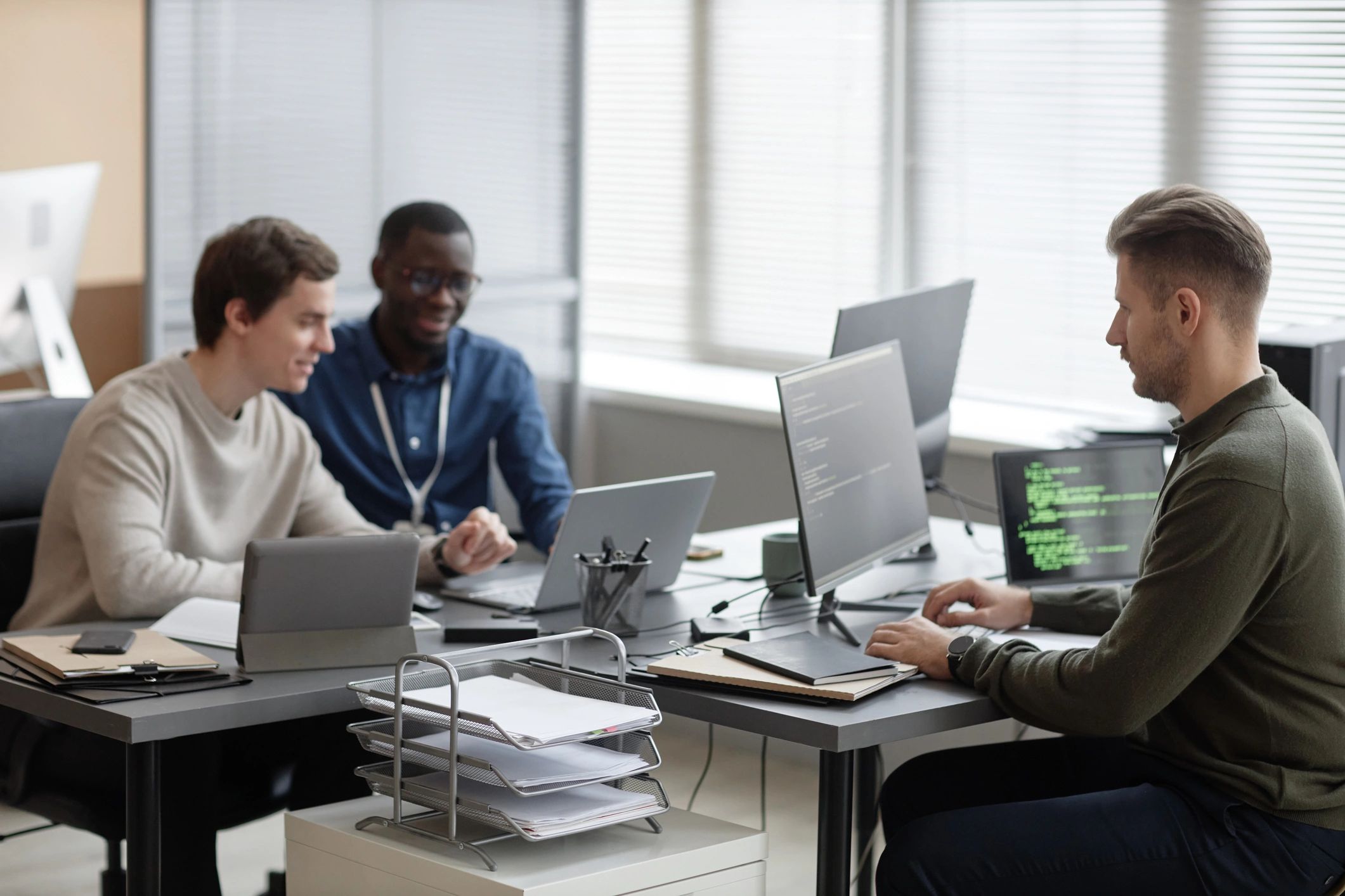 Programmers working in a modern office on a web development project