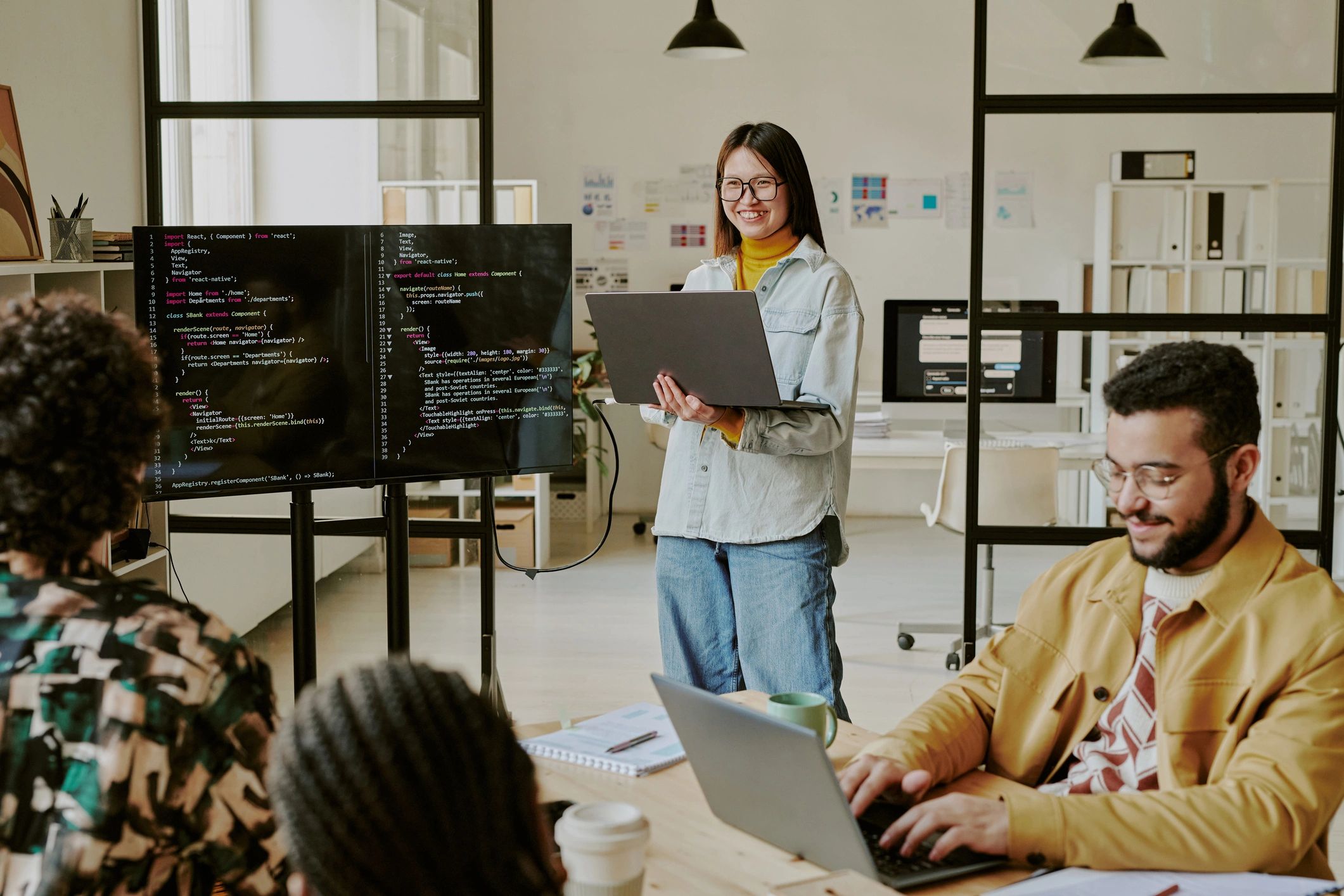 Technology professional presenting coding progress to colleagues