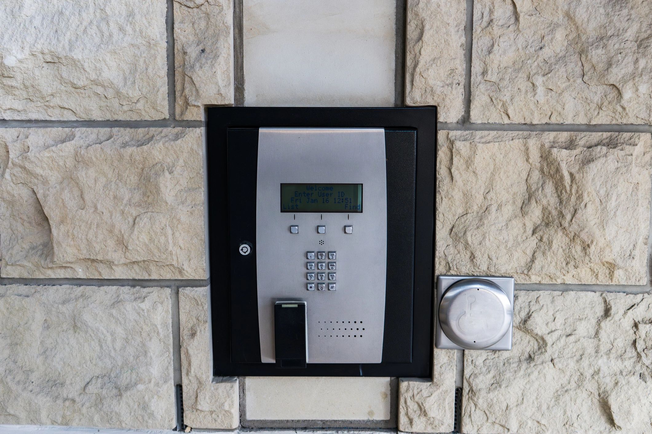 Modern building entry security panel with keypad and intercom