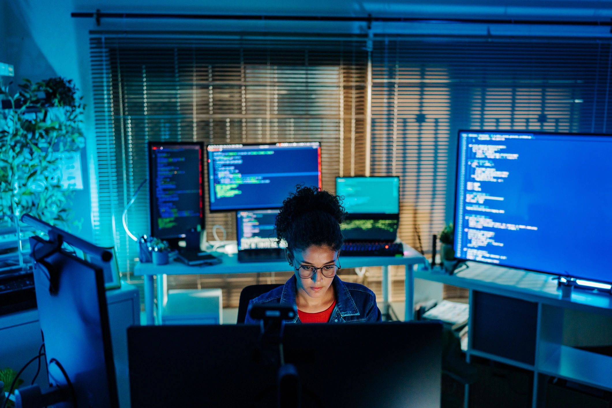 Developer working at a multi-monitor software development workstation